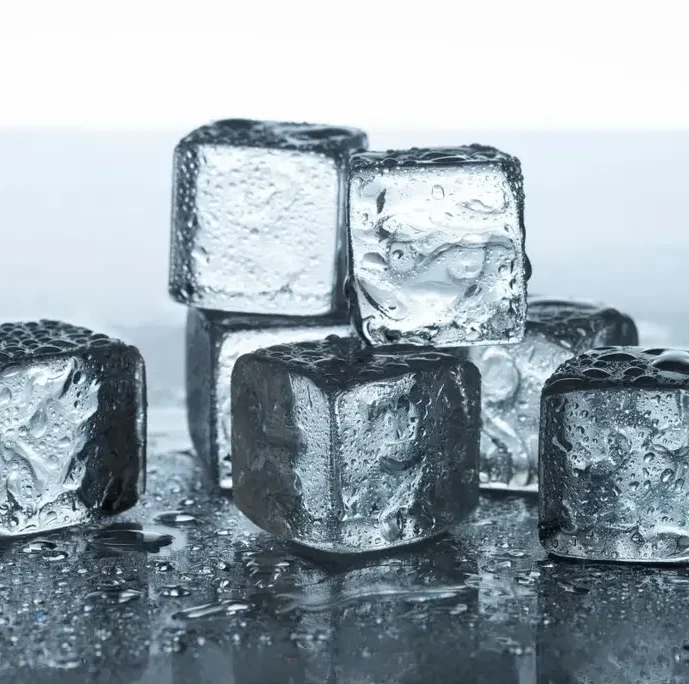 Crystal clear cubic ice cubes stacked on a wet surface - Frost Flare